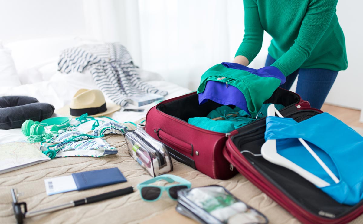 Personal belongings for a trip to Bulgaria, woman packing a suitcase